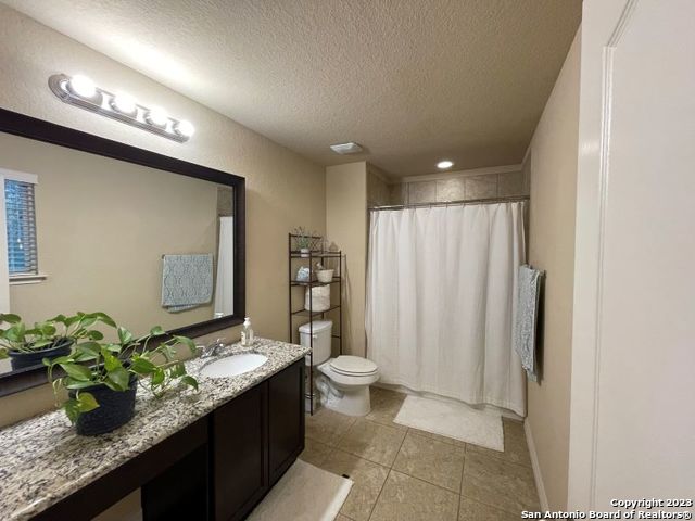 12310 Coal Mine Rise San Antonio, TX 78245 - Photo 10 of 19 a bathroom with a granite countertop sink a toilet and mirror