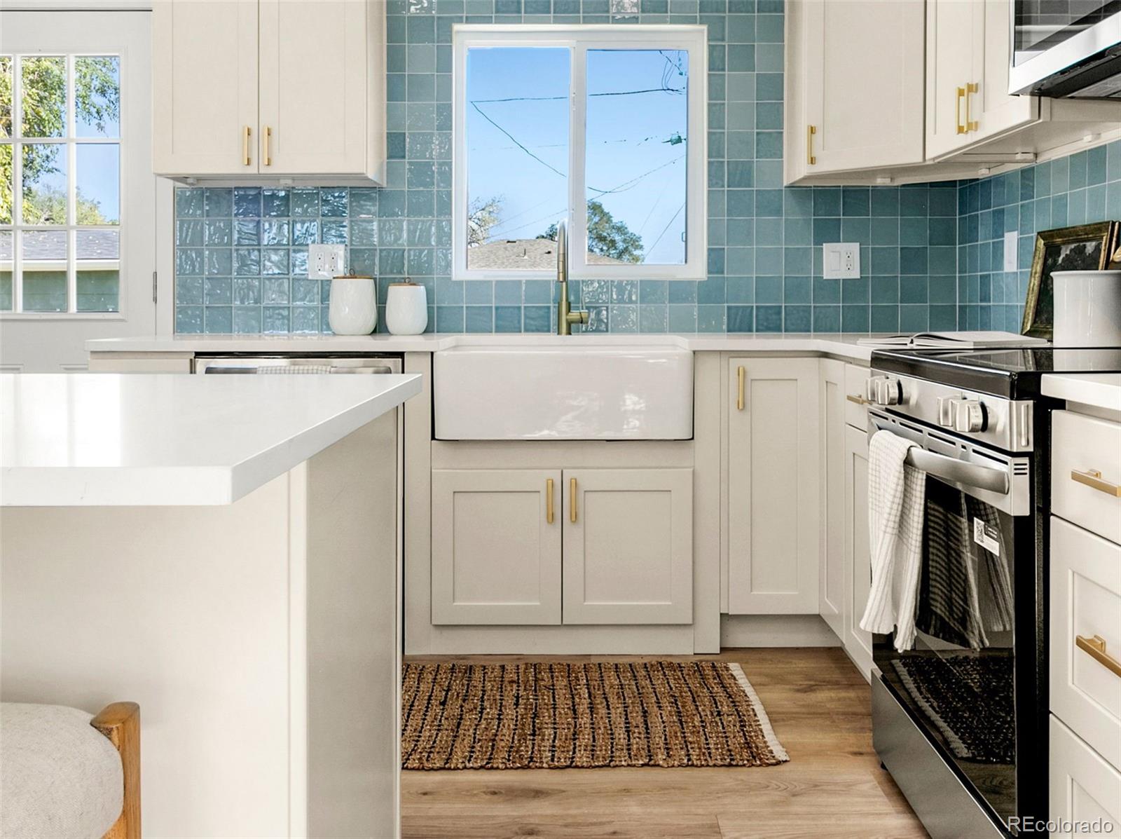 990 Tennyson Street Denver, CO 80204 - Photo 14 of 29 a kitchen with a sink stove and cabinets