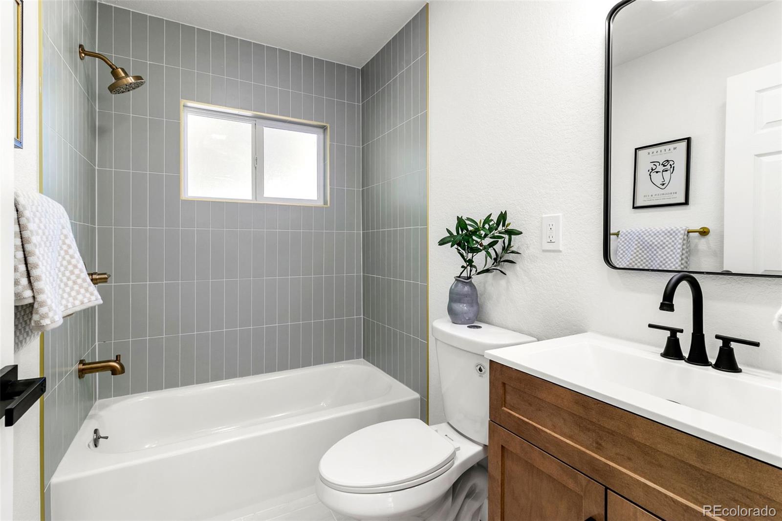 990 Tennyson Street Denver, CO 80204 - Photo 18 of 29 a bathroom with a sink a toilet and shower