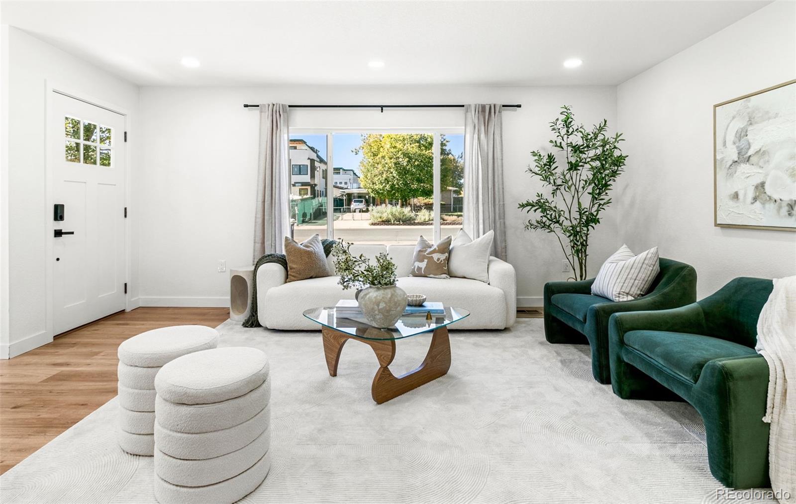 990 Tennyson Street Denver, CO 80204 - Photo 2 of 29 a living room with furniture and a large window