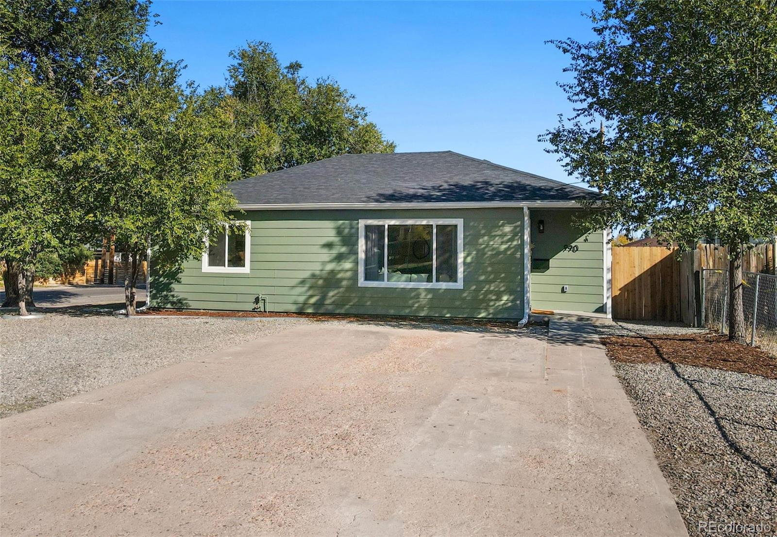 990 Tennyson Street Denver, CO 80204 - Photo 28 of 29 a front view of a house with a yard and garage