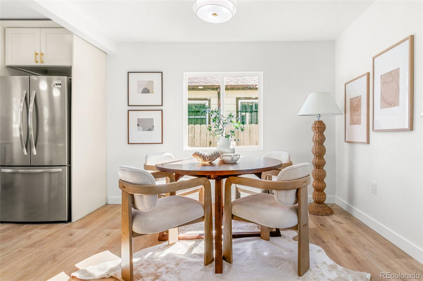 990 Tennyson Street Denver, CO 80204 - Photo 5 of 29 a view of a dining room with furniture and a window