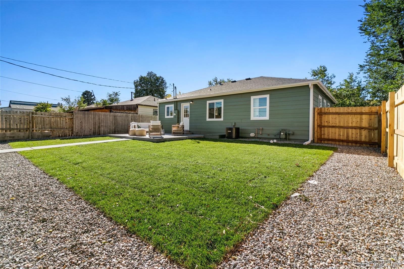 990 Tennyson Street Denver, CO 80204 - Photo 9 of 29 a view of a house with a yard and sitting area