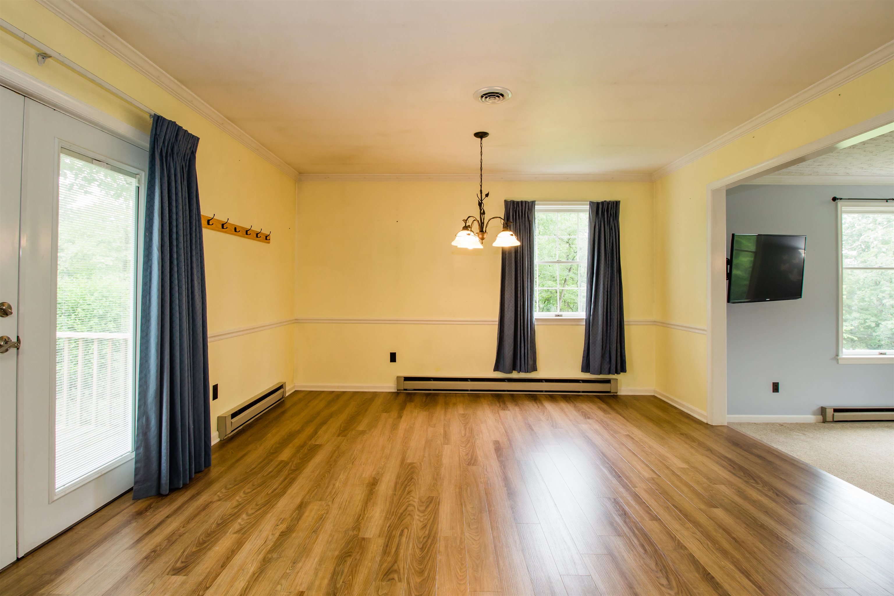 7377 Apple Ridge Drive Timberville, VA 22853 - Photo 6 of 45 a view of an empty room with glass door and wooden floor