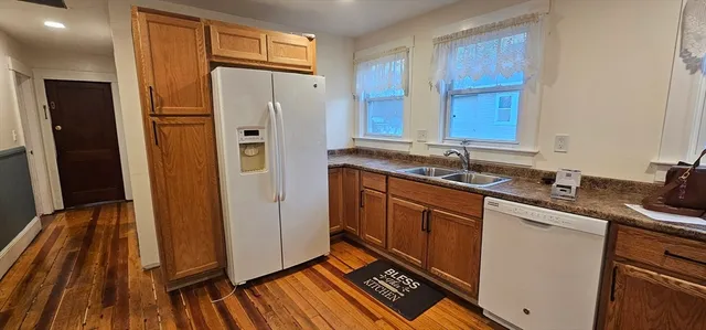 a kitchen with stainless steel appliances granite countertop a refrigerator and a sink
