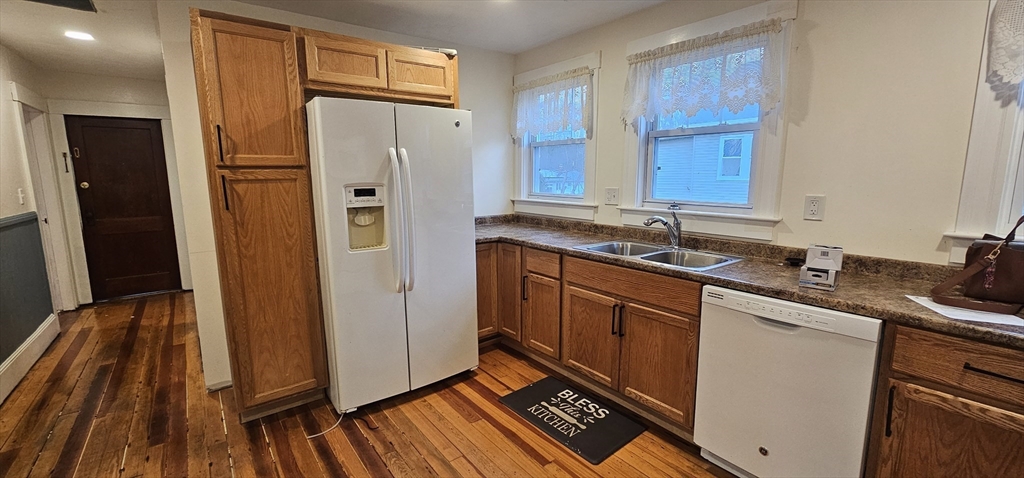 a kitchen with stainless steel appliances granite countertop a refrigerator and a sink