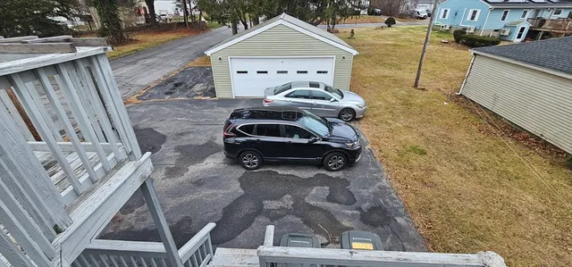 a view of a deck with two chair and wooden floor