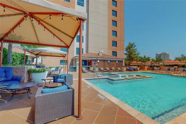 a view of swimming pool with outdoor seating and a patio