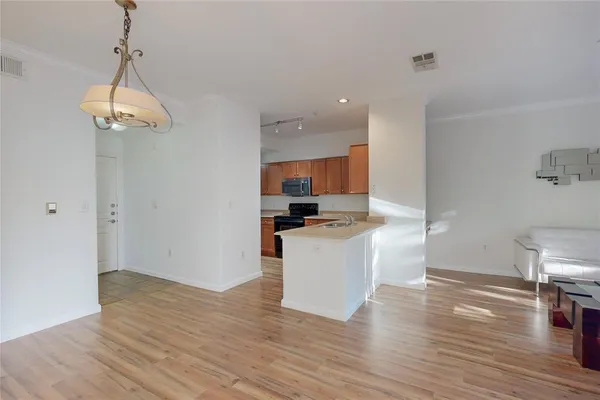 a kitchen with a refrigerator and a stove top oven