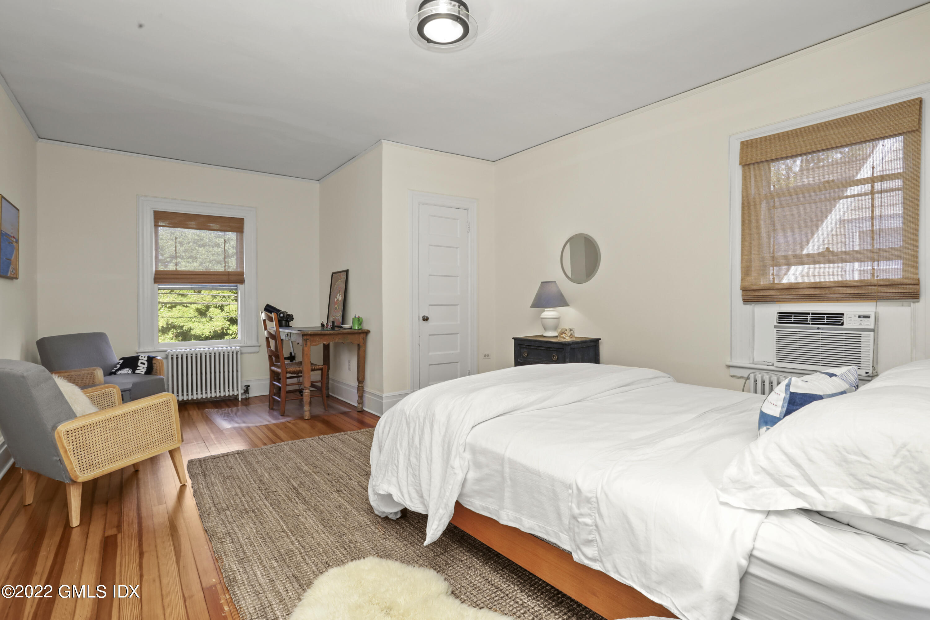 12 Maher Avenue Greenwich, CT 06830 - Photo 15 of 34 a bedroom with a bed and wooden floor