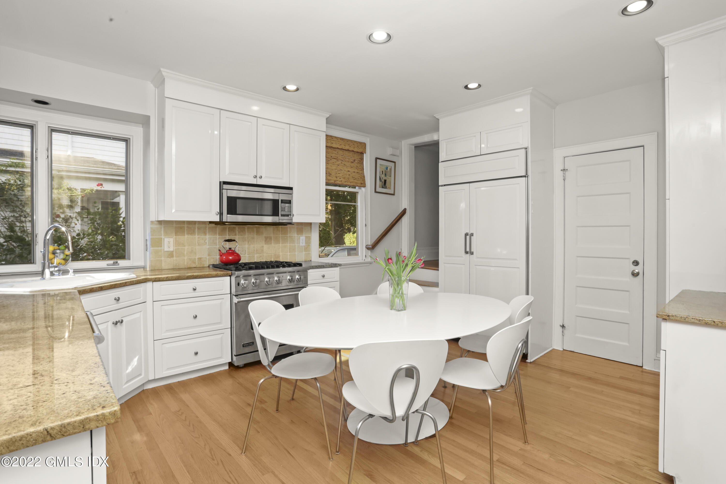 12 Maher Avenue Greenwich, CT 06830 - Photo 6 of 34 a kitchen with granite countertop white cabinets and stainless steel appliances