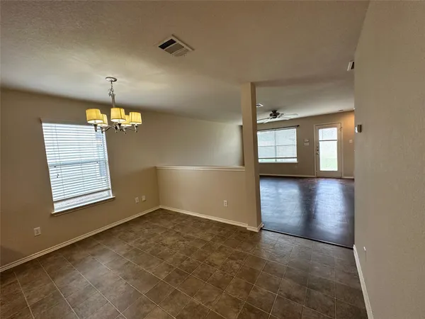 an empty room with windows and entrance