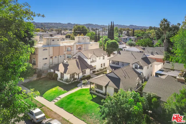 an aerial view of a residential apartment building with a yard
