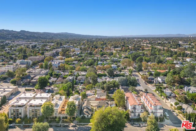 an aerial view of residential building with green space