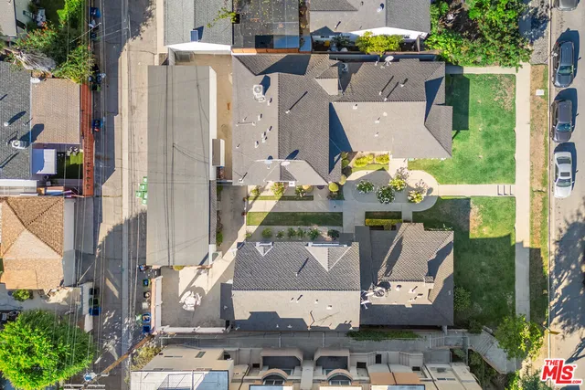 an aerial view of multiple houses with outdoor space
