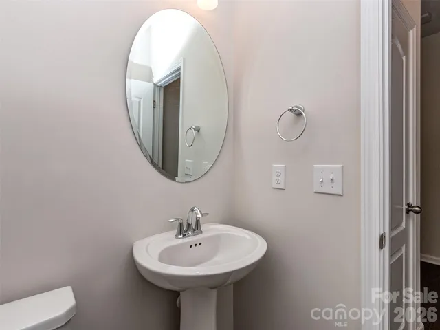 a bathroom with a sink a mirror and a toilet