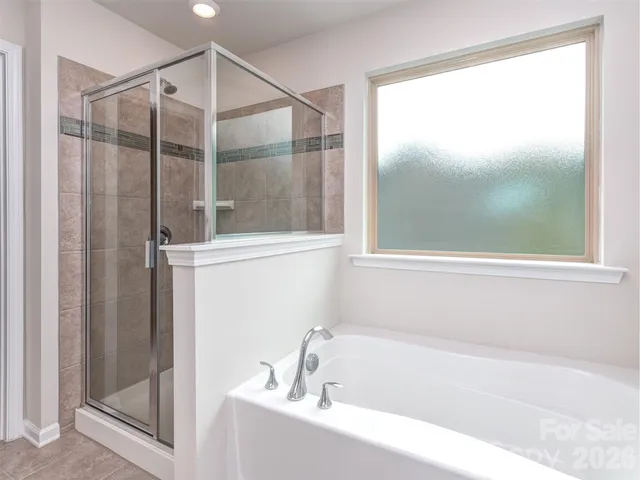 a bathroom with a bathtub and shower