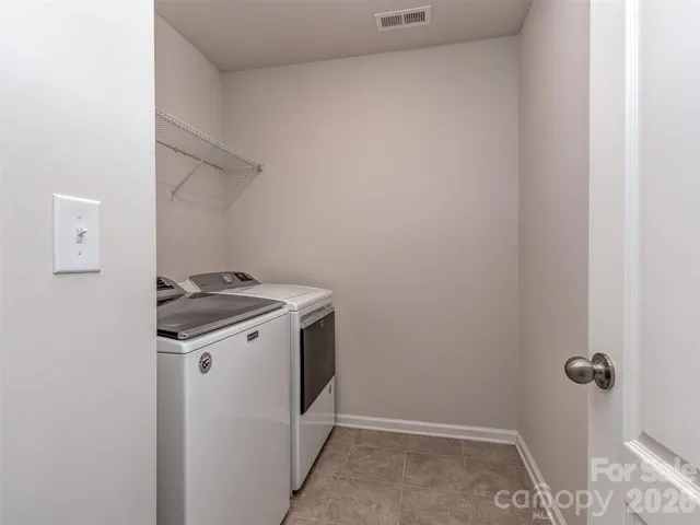 a view of storage and utility room with washer and dryer