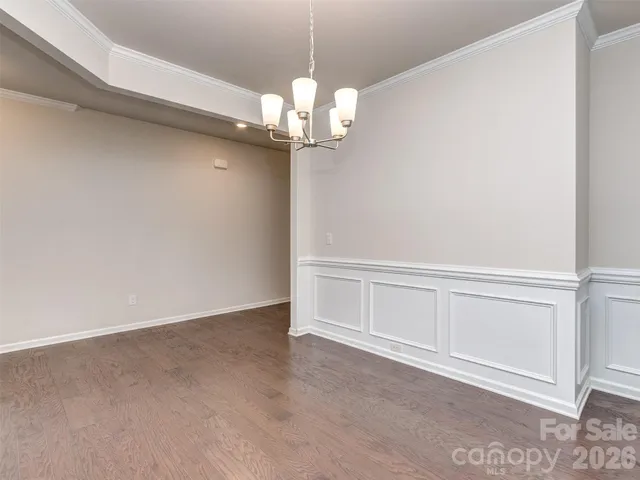 a view of an empty room with chandelier