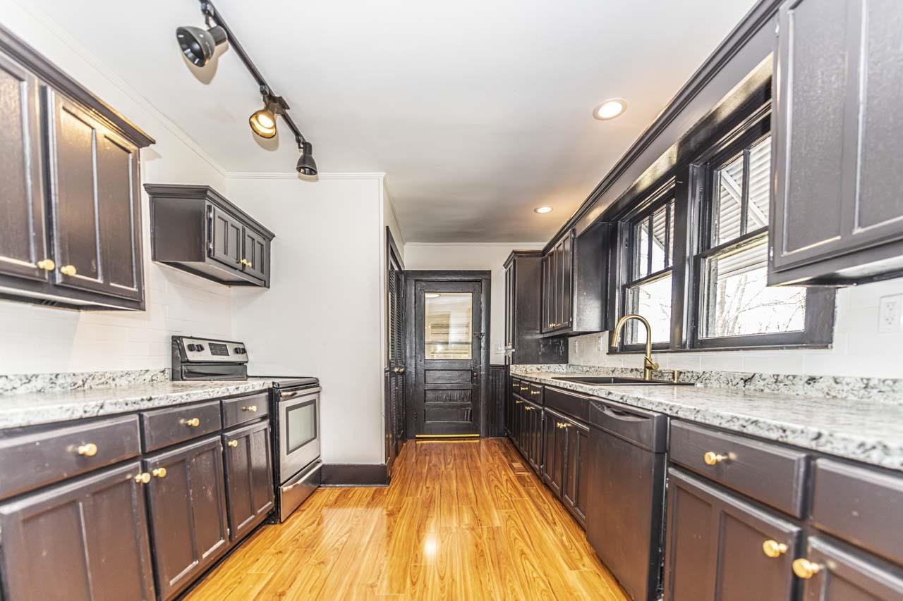4615 Highway 54 Covington, TN 38019 - Photo 7 of 24 a kitchen with stainless steel appliances granite countertop a sink stove and cabinets