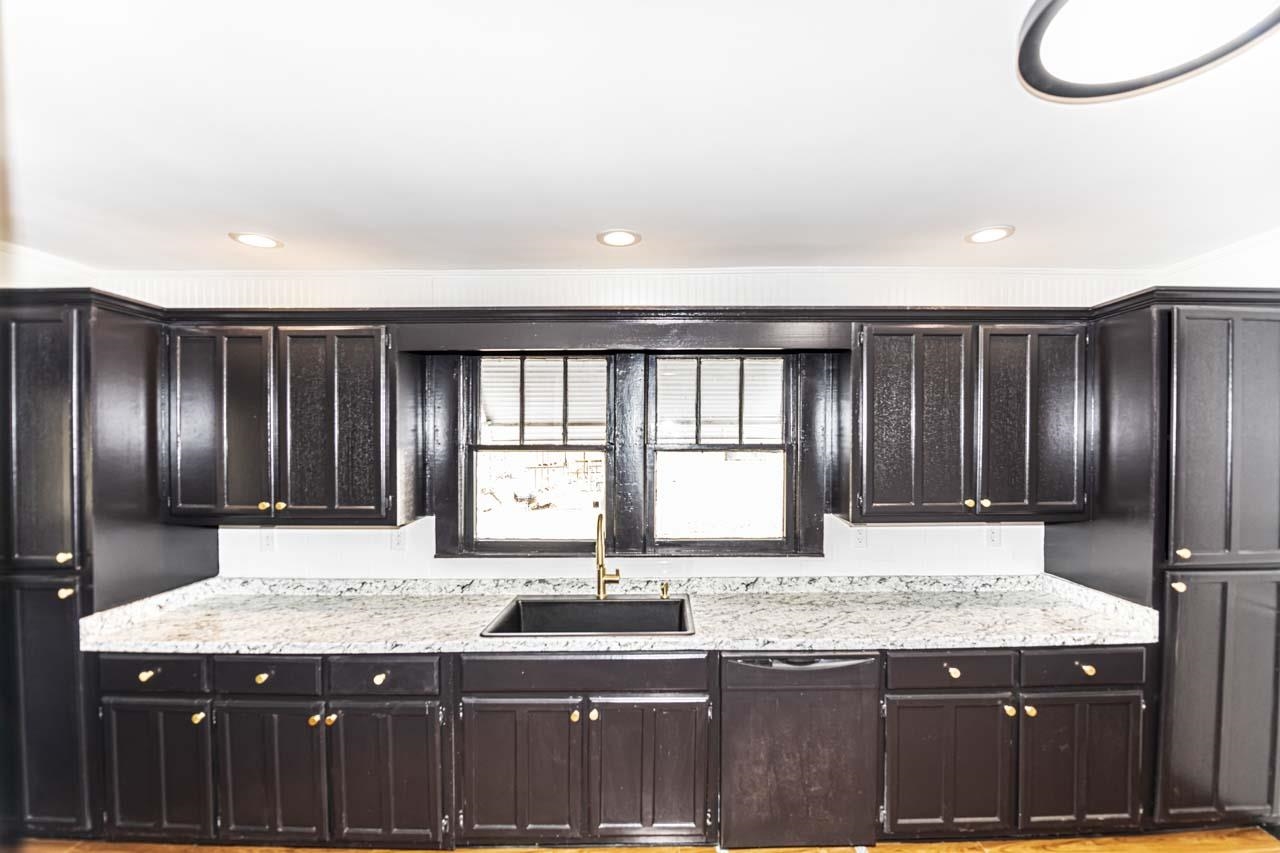 4615 Highway 54 Covington, TN 38019 - Photo 8 of 24 a kitchen with granite countertop stainless steel appliances and sink