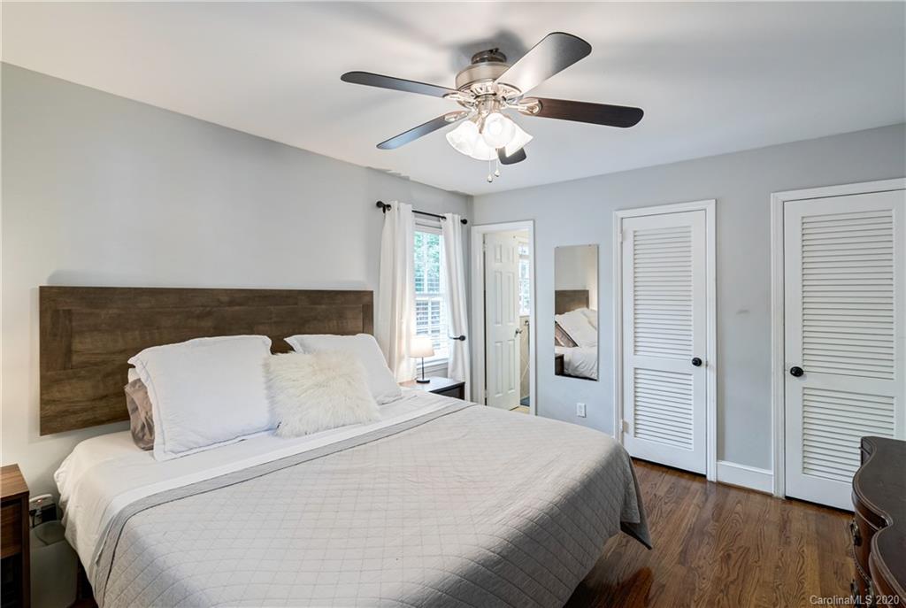 7026 Morganford Road Charlotte, NC 28211 - Photo 15 of 35 a bedroom with a large bed and a chandelier