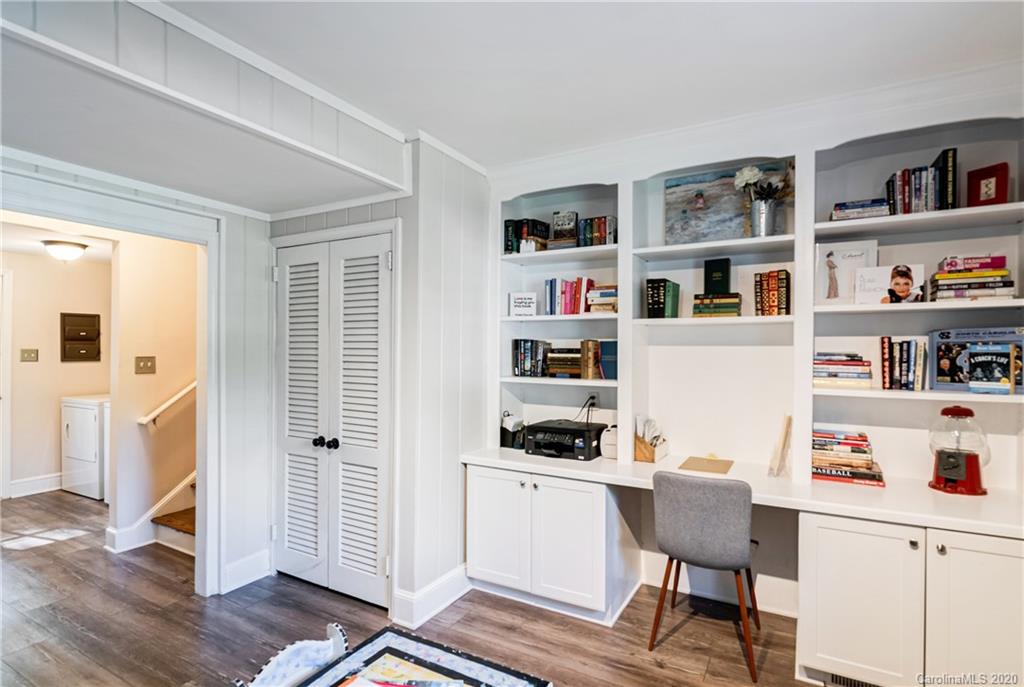 7026 Morganford Road Charlotte, NC 28211 - Photo 20 of 35 a workspace with furniture and a book shelf