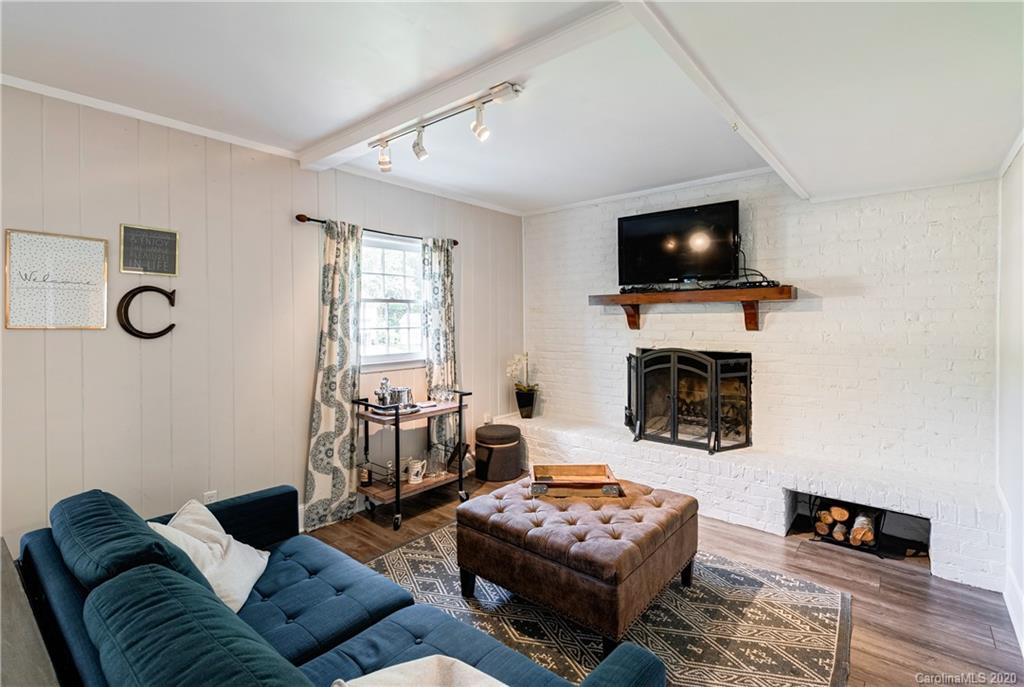 7026 Morganford Road Charlotte, NC 28211 - Photo 21 of 35 a living room with furniture a flat screen tv and a fireplace