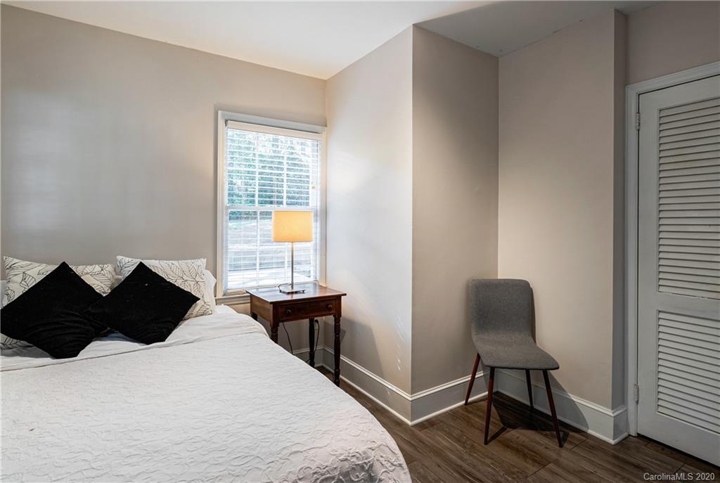 7026 Morganford Road Charlotte, NC 28211 - Photo 24 of 35 a bedroom with a bed chair and a window