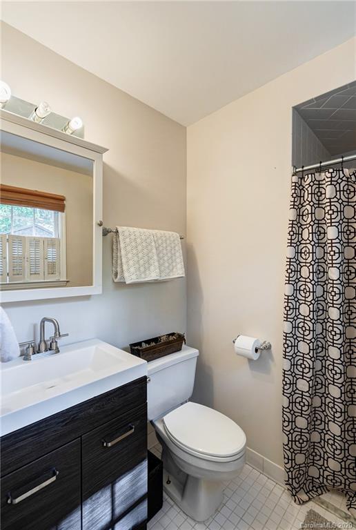 7026 Morganford Road Charlotte, NC 28211 - Photo 25 of 35 a bathroom with a sink toilet vanity and mirror