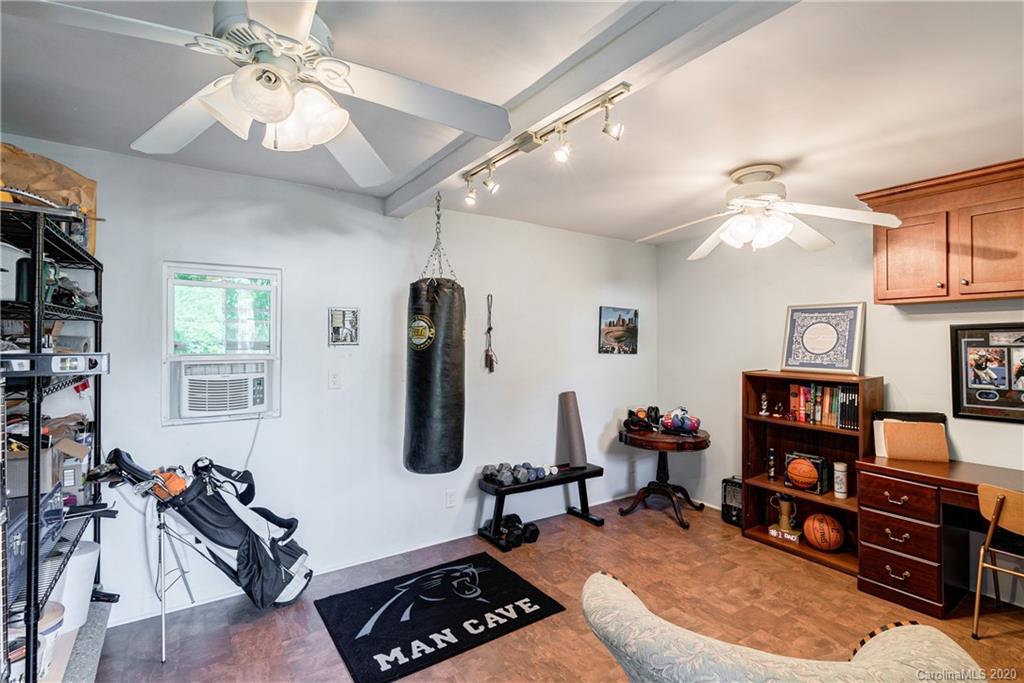 7026 Morganford Road Charlotte, NC 28211 - Photo 32 of 35 a room with furniture and a flat screen tv