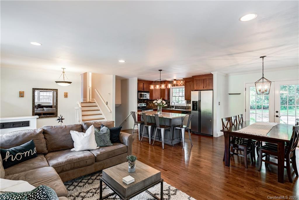 7026 Morganford Road Charlotte, NC 28211 - Photo 8 of 35 a living room with furniture a wooden floor and chandelier