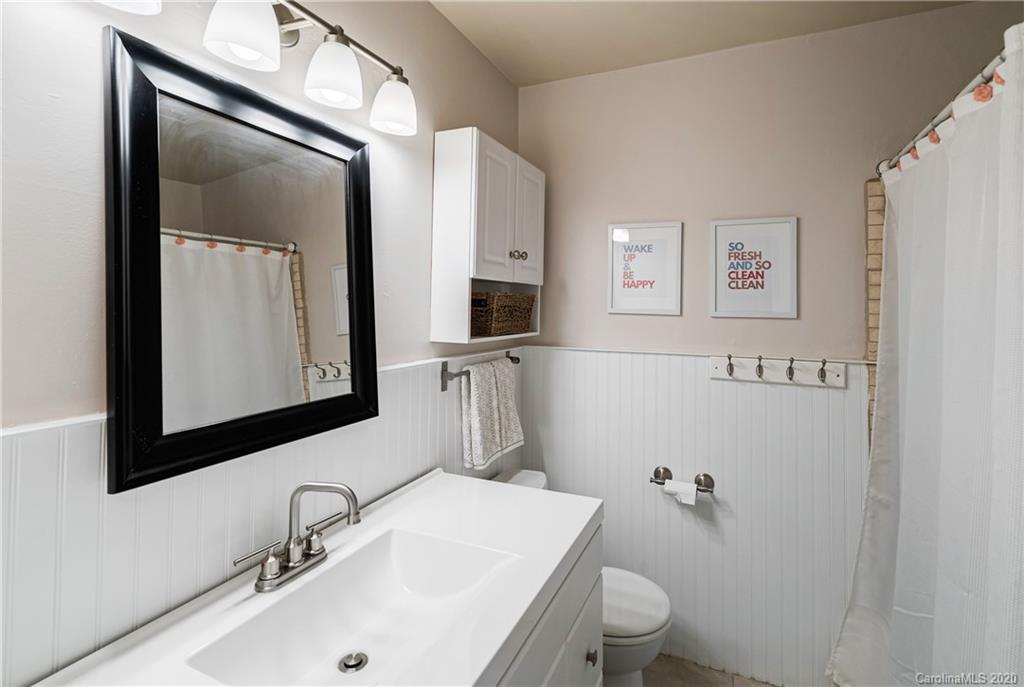 7026 Morganford Road Charlotte, NC 28211 - Photo 10 of 35 a bathroom with a sink toilet and mirror