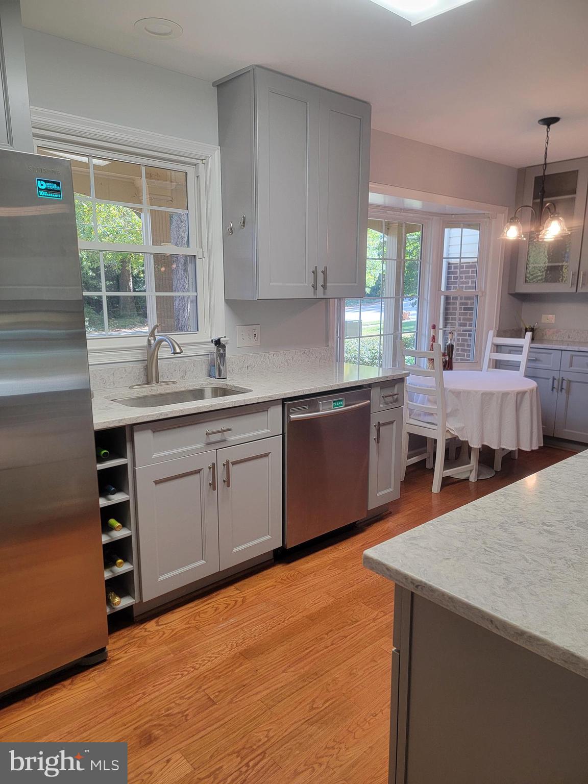 7128 Devonshire Road Alexandria, VA 22307 - Photo 15 of 36 a kitchen with stainless steel appliances a sink window and cabinets