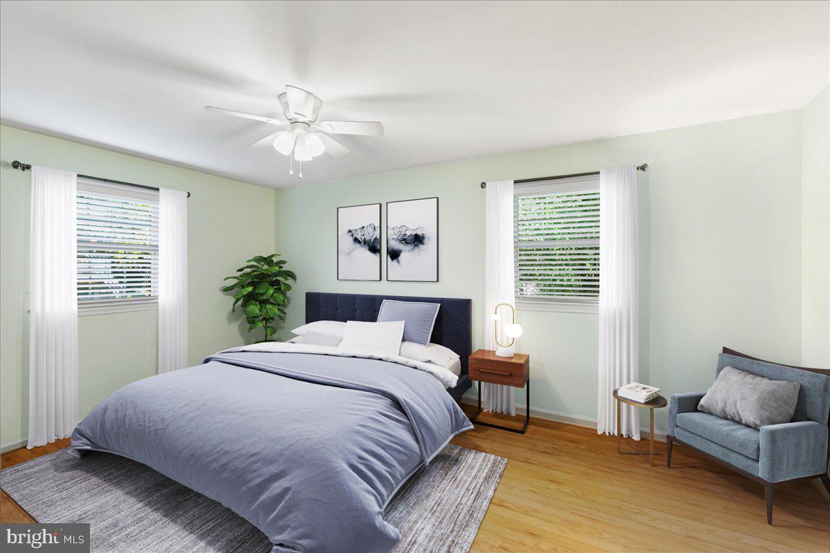 7128 Devonshire Road Alexandria, VA 22307 - Photo 19 of 36 a bedroom with a large bed and a couch