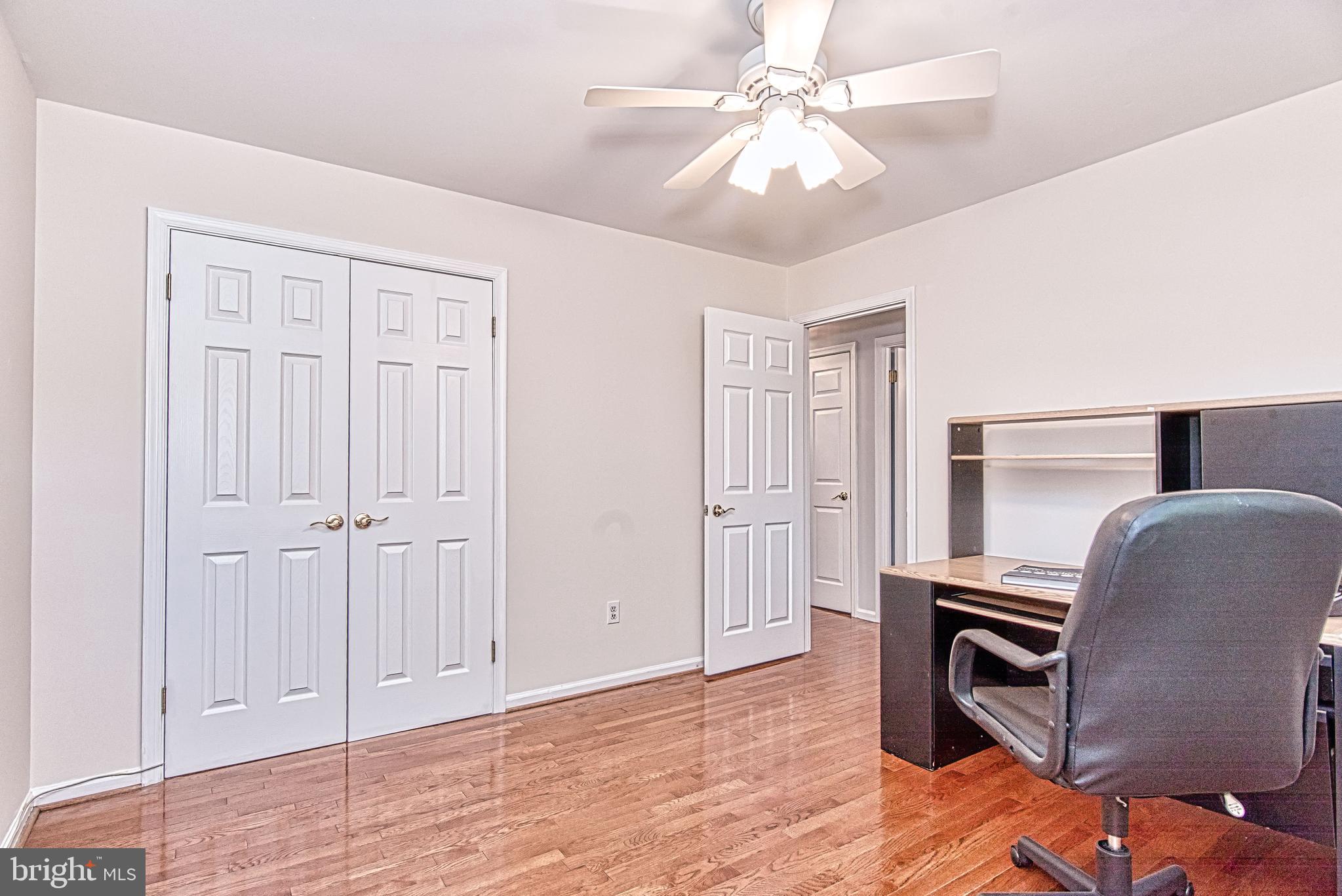 7128 Devonshire Road Alexandria, VA 22307 - Photo 25 of 36 a view of a livingroom with furniture and a ceiling fan