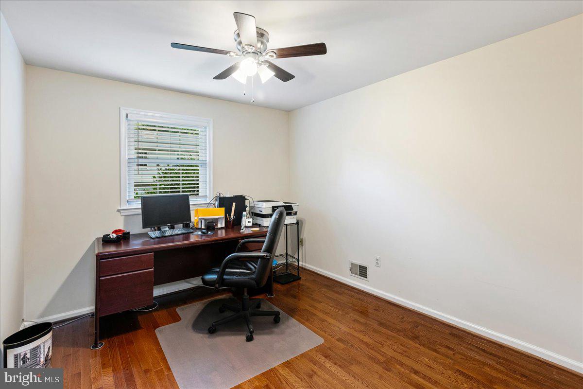 7128 Devonshire Road Alexandria, VA 22307 - Photo 27 of 36 a view of a workspace with furniture and a window