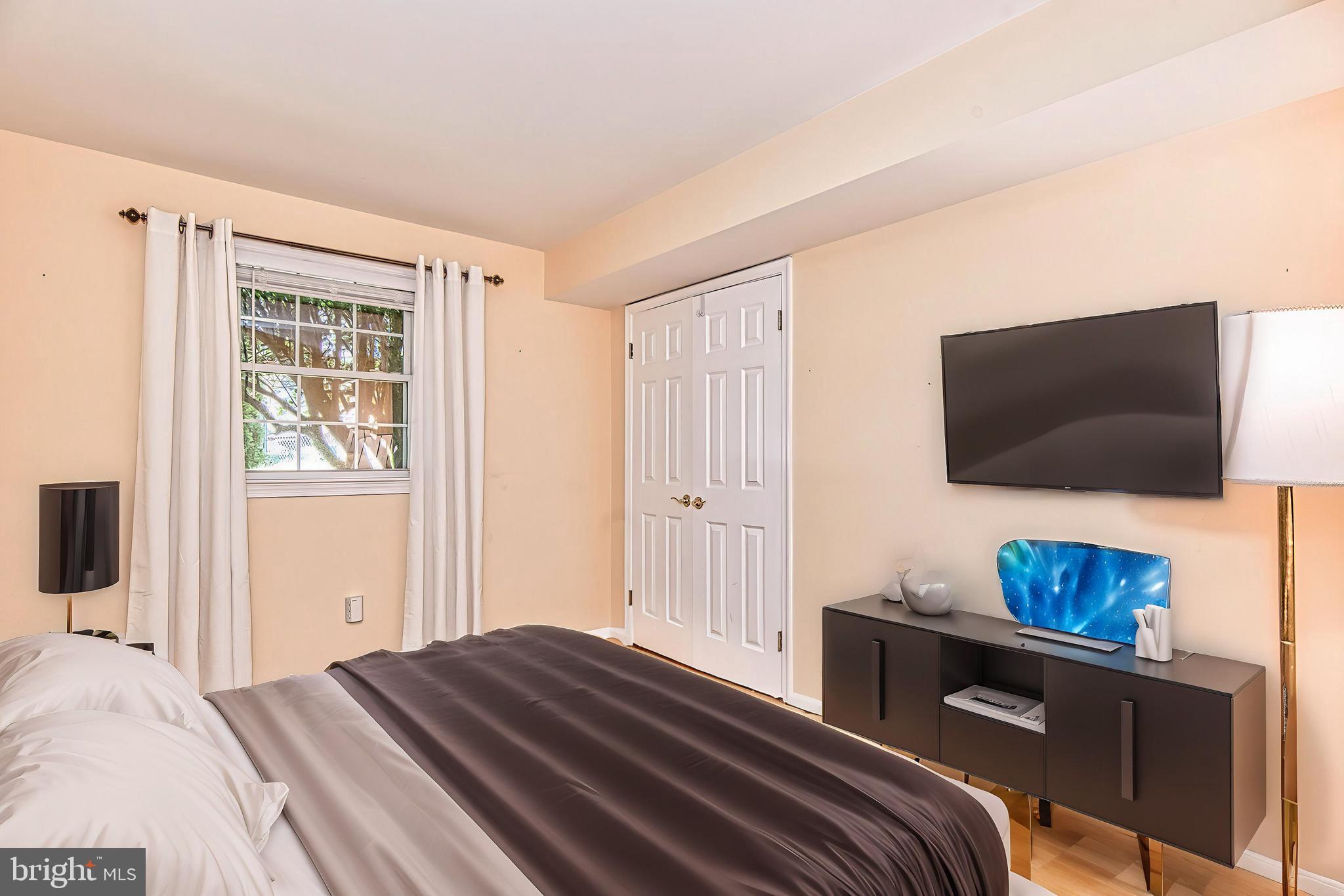 7128 Devonshire Road Alexandria, VA 22307 - Photo 28 of 36 a bedroom with a bed and a television