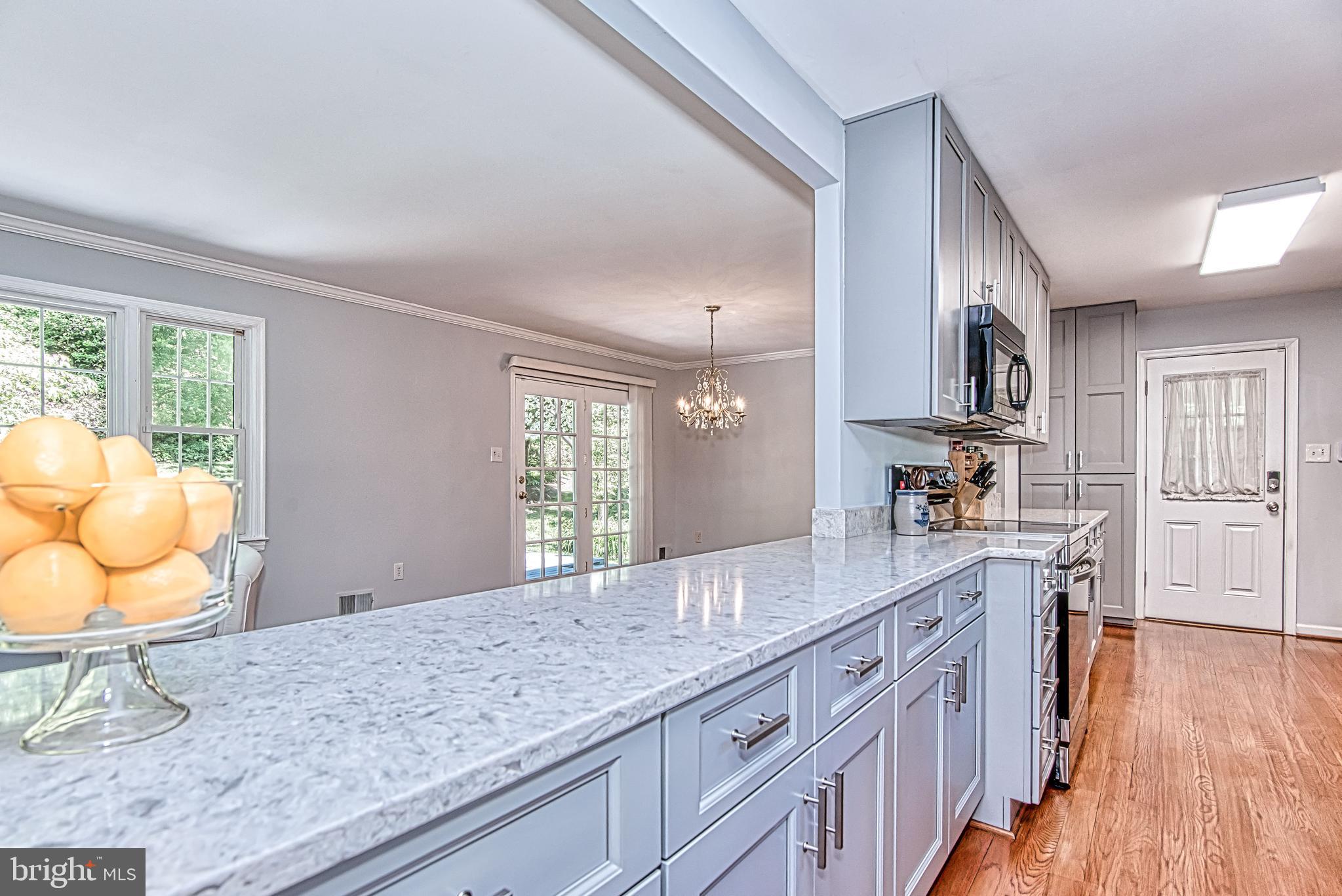 7128 Devonshire Road Alexandria, VA 22307 - Photo 3 of 36 a spacious bathroom with a granite countertop sink mirror and a window