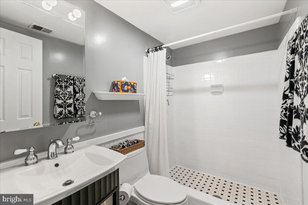 7128 Devonshire Road Alexandria, VA 22307 - Photo 7 of 36 a bathroom with a sink toilet and shower
