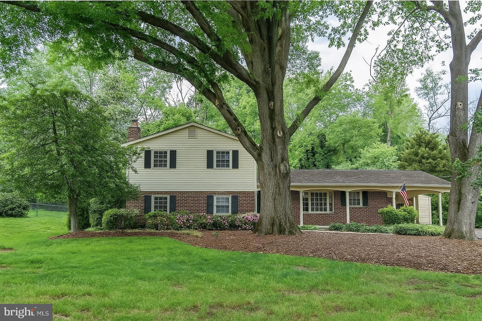 7128 Devonshire Road Alexandria, VA 22307 - Photo 8 of 36 a front view of a house with a garden and yard