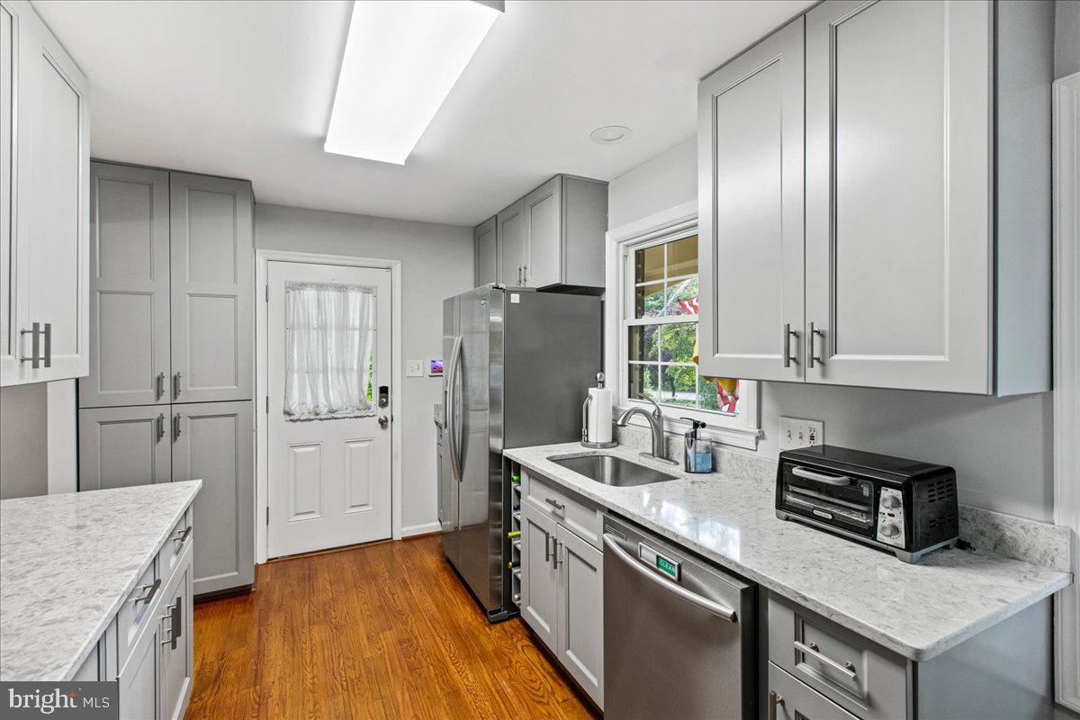 7128 Devonshire Road Alexandria, VA 22307 - Photo 10 of 36 a kitchen with a refrigerator and a sink