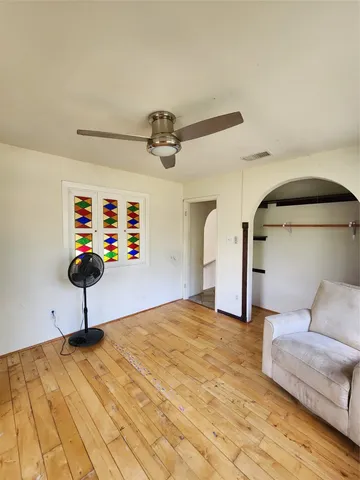 a living room with couch and a ceiling fan