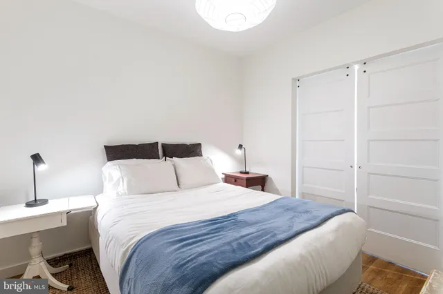 a bedroom with a bed and a table