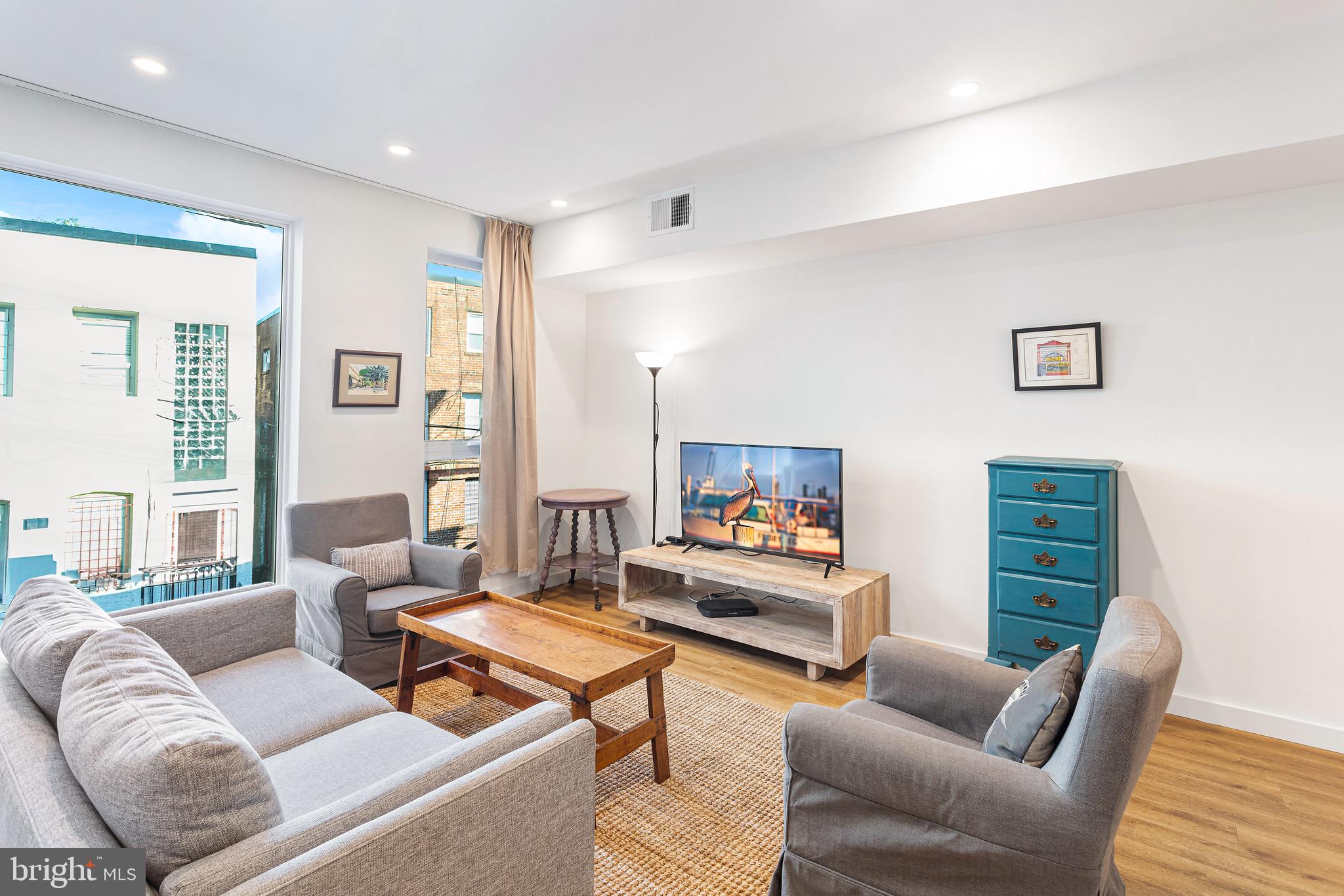2465 18th Street Northwest, Unit 2 Washington, DC 20009 - Photo 4 of 18 a living room with furniture a rug and a window