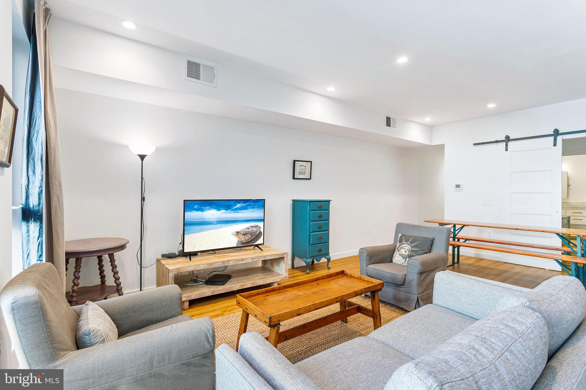 2465 18th Street Northwest, Unit 2 Washington, DC 20009 - Photo 5 of 18 a living room with furniture and a flat screen tv