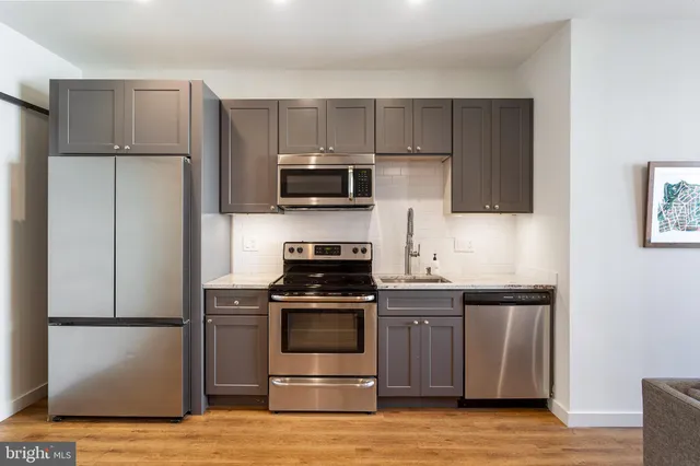 a kitchen with a sink and steel stainless steel appliances