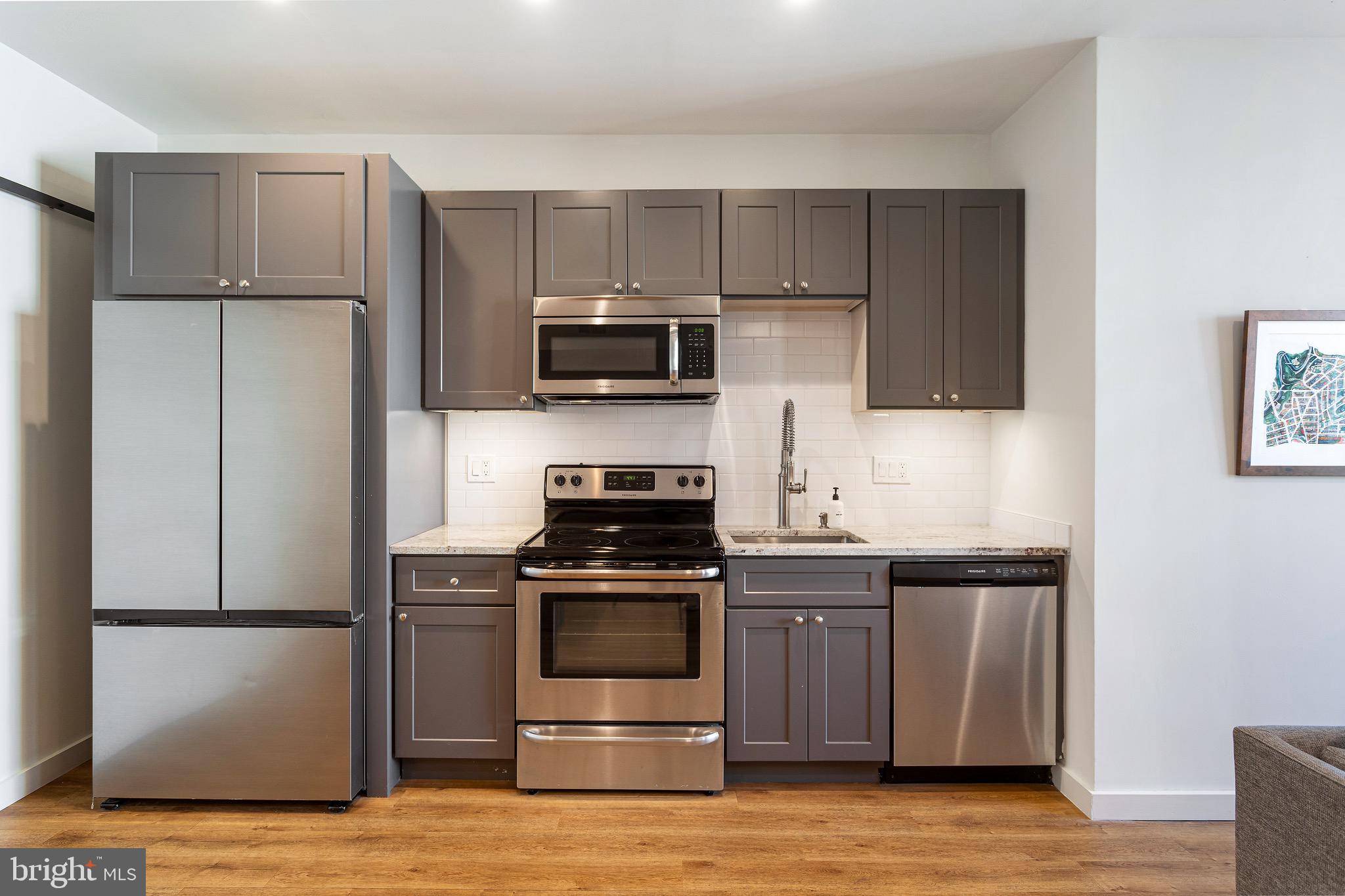 2465 18th Street Northwest, Unit 2 Washington, DC 20009 - Photo 7 of 18 a kitchen with a sink and steel stainless steel appliances