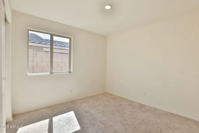 a view of an empty room and closet area
