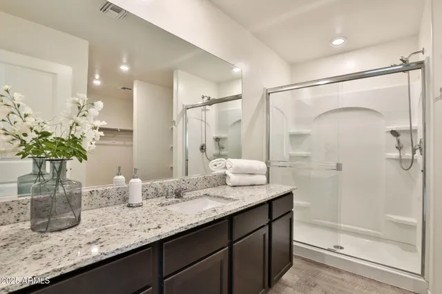 a bathroom with a granite countertop sink and a mirror